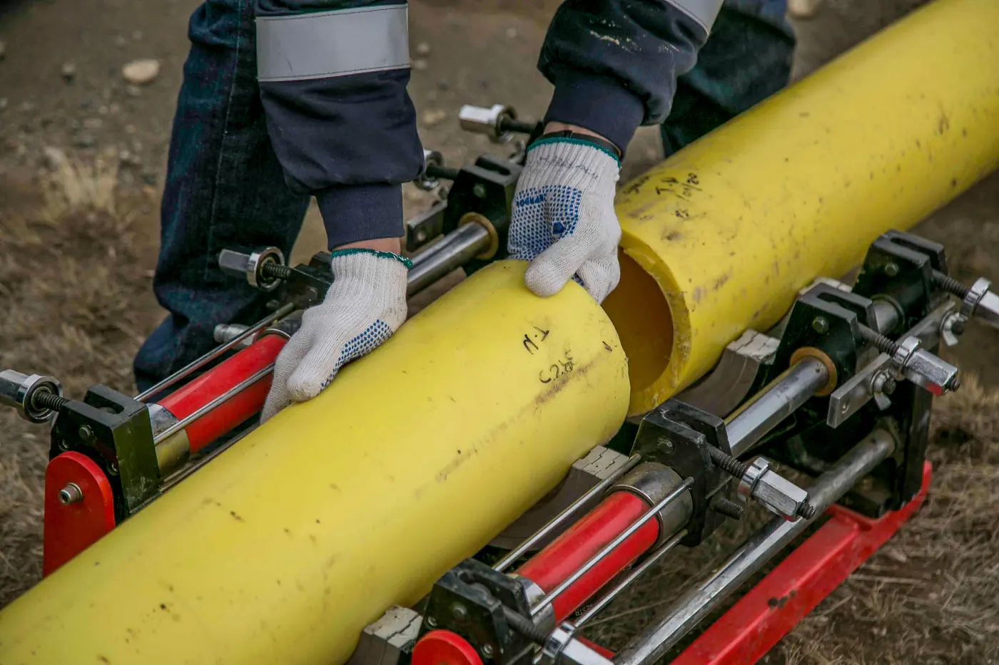 Field crew aligning and clamping pipe sections